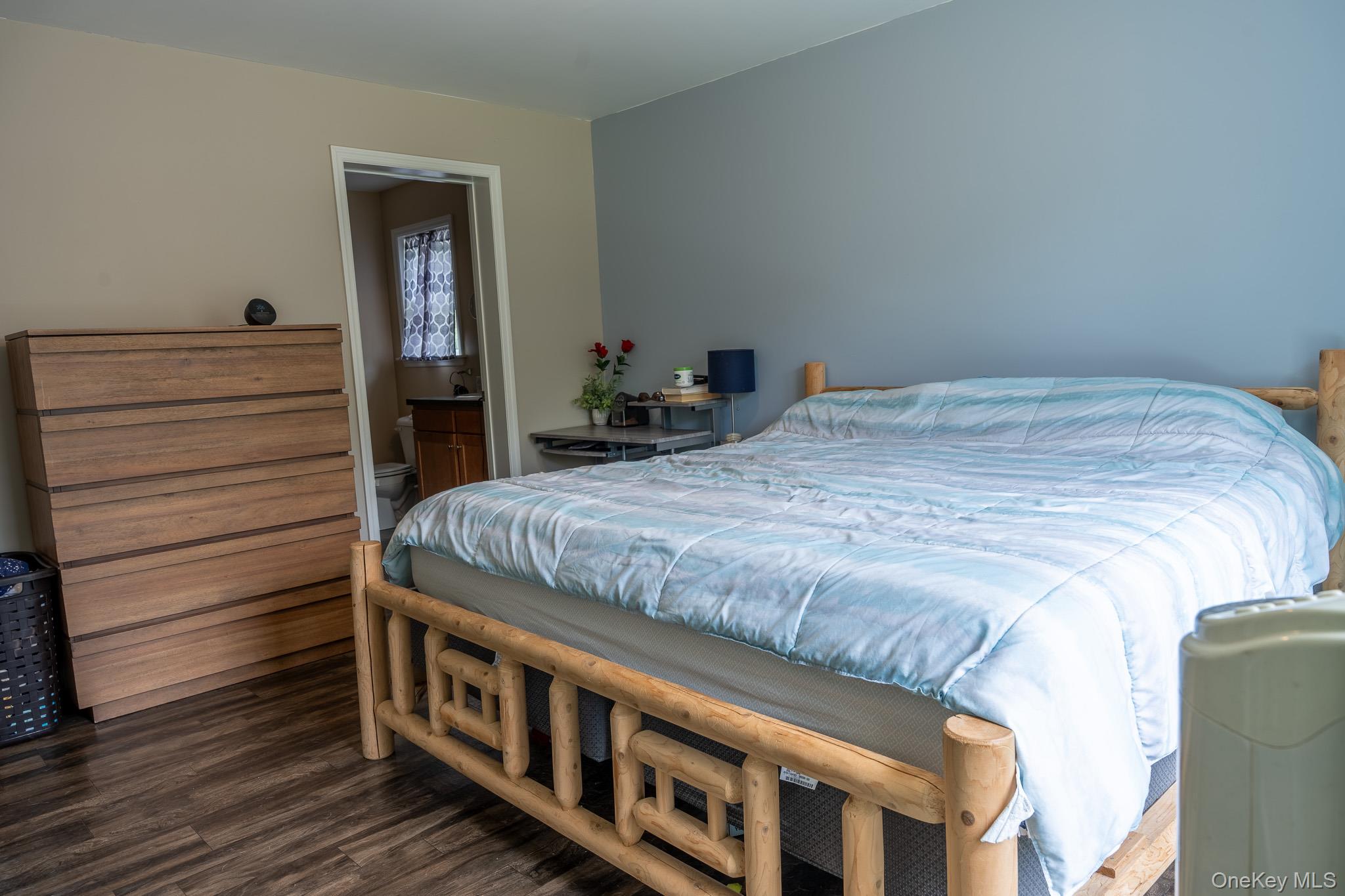 56 Ahrens Road Parksville, NY 12768 - Photo 14 of 23 a bed sitting in a bedroom next to a window