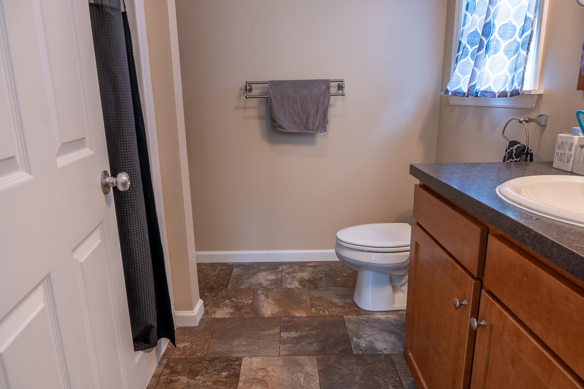 56 Ahrens Road Parksville, NY 12768 - Photo 15 of 23 Full bathroom featuring stone finish flooring, vanity, and curtained shower