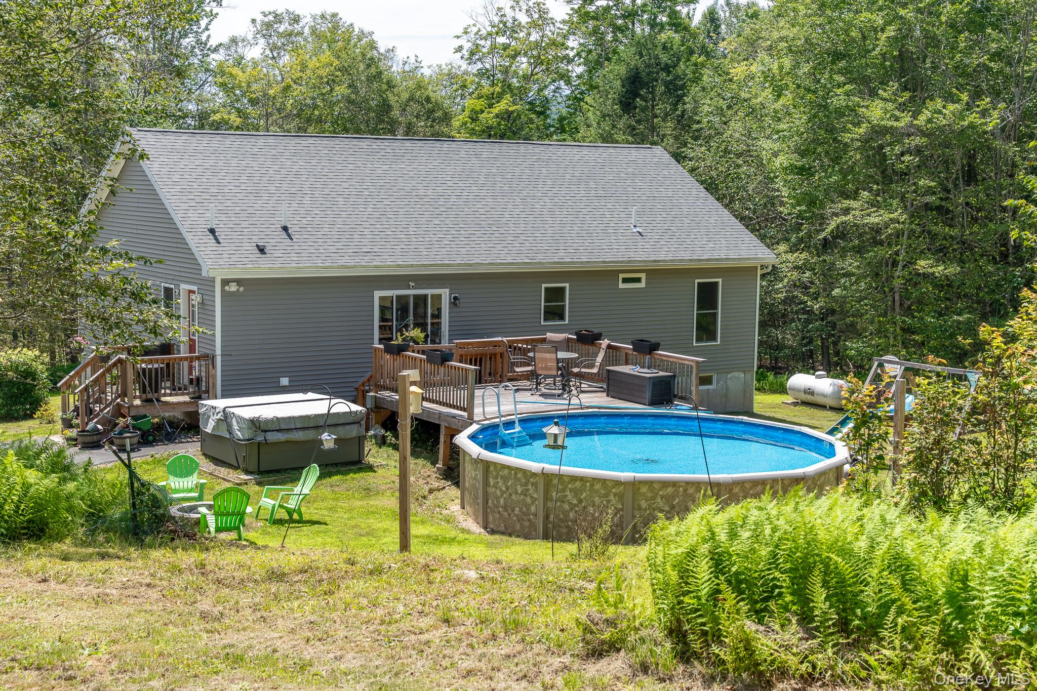 56 Ahrens Road Parksville, NY 12768 - Photo 21 of 23 a view of a patio with table and chairs potted plants and large tree