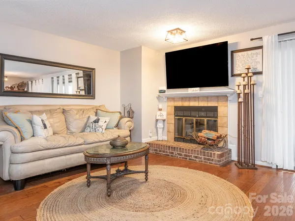a living room with furniture and a clock