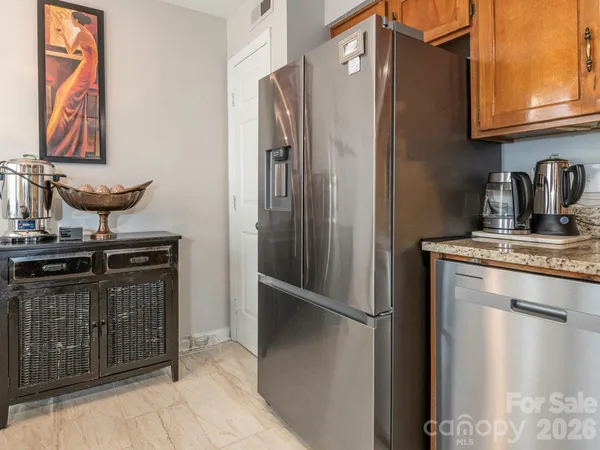 a kitchen with stainless steel appliances granite countertop a sink and cabinets