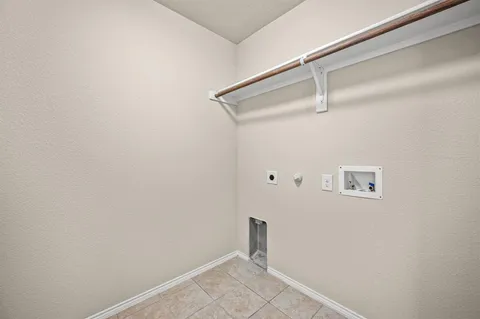 a view of an empty room with window and cabinet