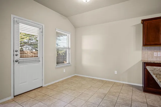 a kitchen with stainless steel appliances granite countertop a sink and a refrigerator