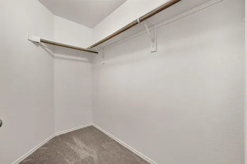 a large kitchen with granite countertop a stove top oven a sink a counter space and cabinets