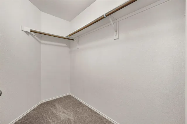 a large kitchen with granite countertop a stove top oven a sink a counter space and cabinets