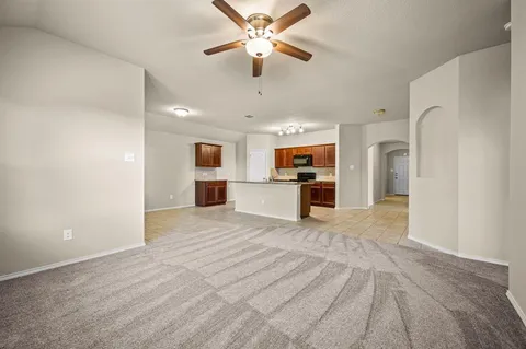 a view of a kitchen with a sink and a refrigerator