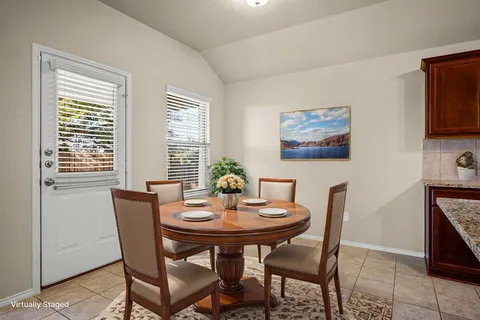 a view of a dining room with furniture and window
