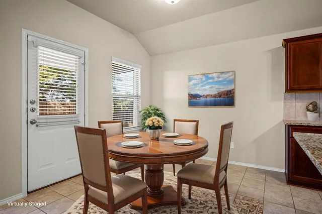 a view of a dining room with furniture and window