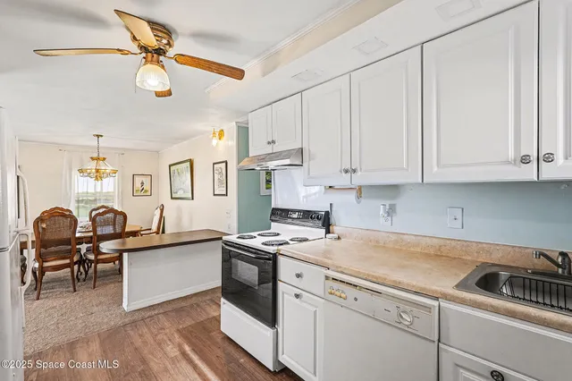 a kitchen that has a lot of cabinets in it and appliances
