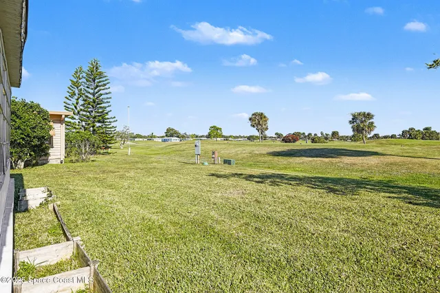 a view of a big yard with an outdoor space and seating area