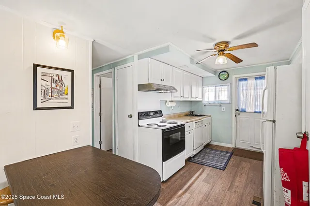 a kitchen with stainless steel appliances granite countertop a stove a refrigerator and a microwave