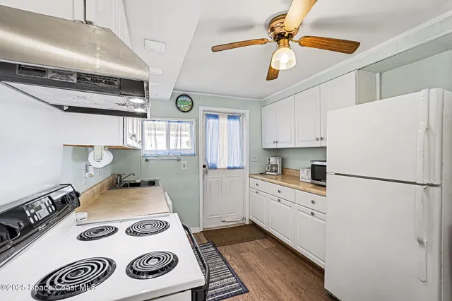 a kitchen with a white stove top oven and refrigerator