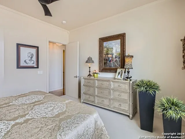 a bedroom with a bed and a potted plant