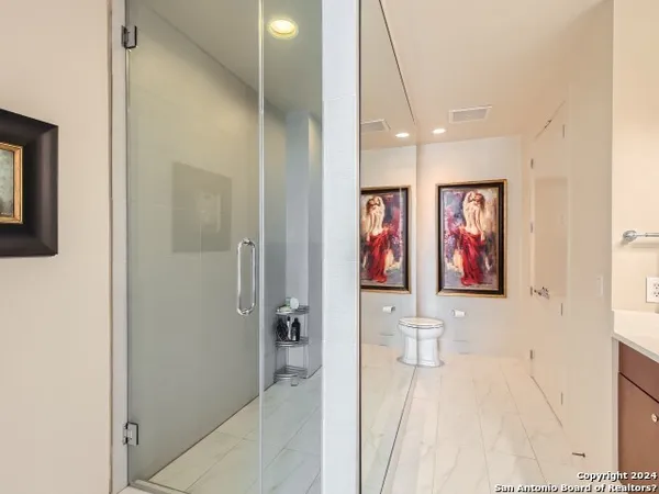 a view of a hallway with paintings on the wall