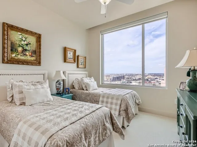a bedroom with a bed and a large window