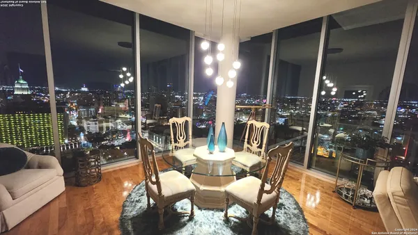 a view of a patio with dining table and chairs
