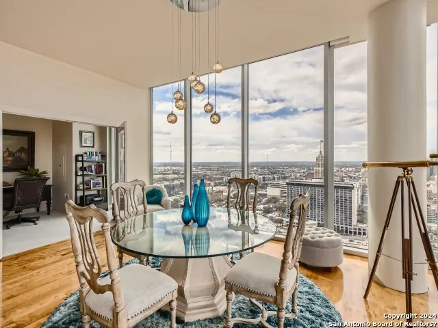 a dining room with furniture water view and wooden floor