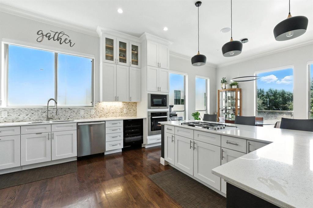 101 Decker Drive, Unit 301 Irving, TX 75062 - Photo 11 of 32 a large kitchen with stainless steel appliances granite countertop stove a sink dishwasher and a refrigerator with wooden floor