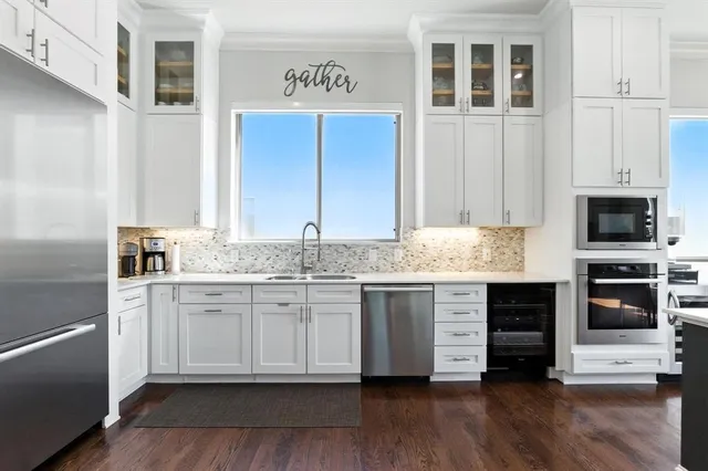 a kitchen with stainless steel appliances granite countertop a stove and a refrigerator