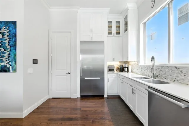a kitchen with stainless steel appliances granite countertop a refrigerator and a sink