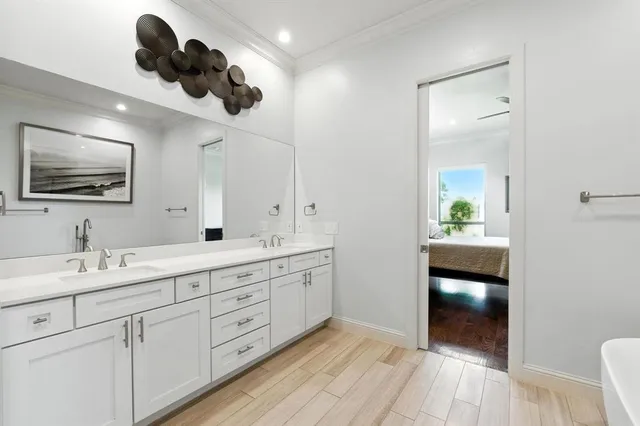 a bathroom with a double vanity sink and a mirror