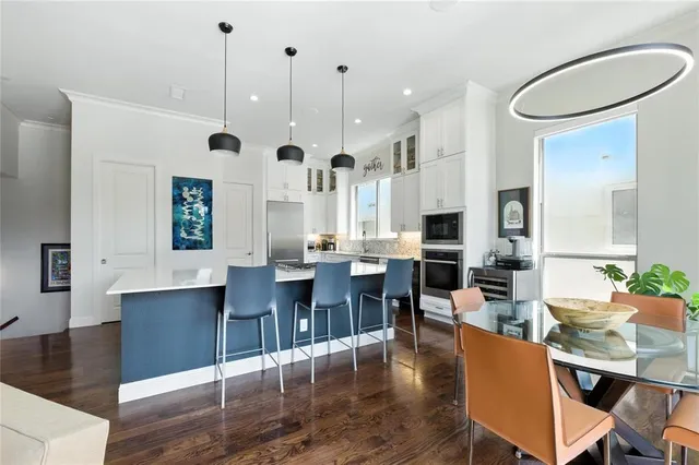 a large kitchen with a table and chairs