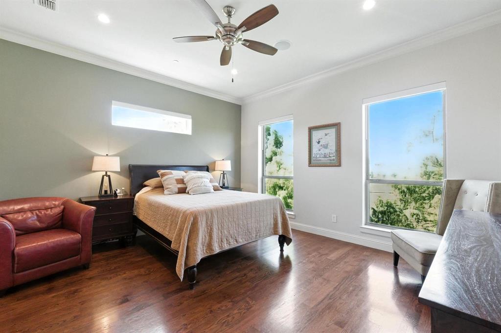 101 Decker Drive, Unit 301 Irving, TX 75062 - Photo 20 of 32 a bedroom with a bed lamp and wooden floor