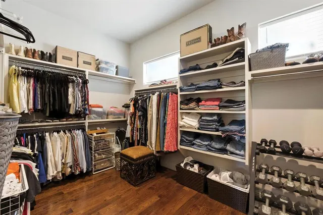 a view of walk in closet with clothes and shoes