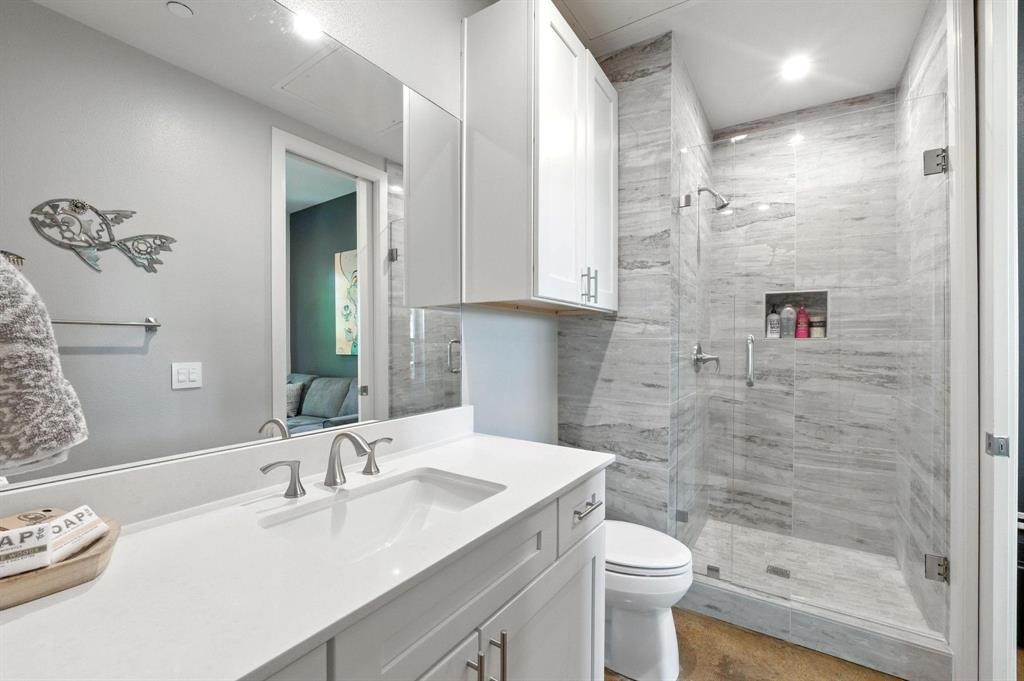 101 Decker Drive, Unit 301 Irving, TX 75062 - Photo 29 of 32 a bathroom with a sink a toilet and shower