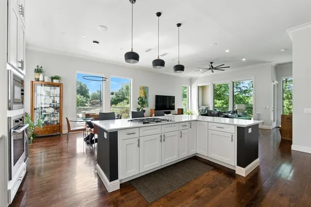 a open kitchen with stainless steel appliances granite countertop a stove and cabinets