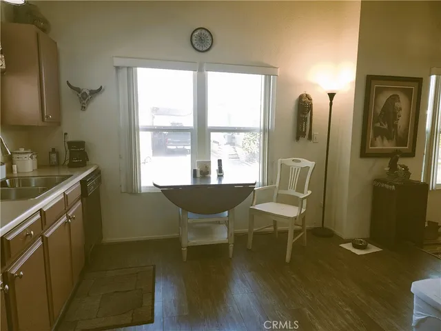 a kitchen with granite countertop a refrigerator stove and sink