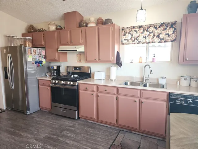a kitchen with a sink cabinets and wooden floor