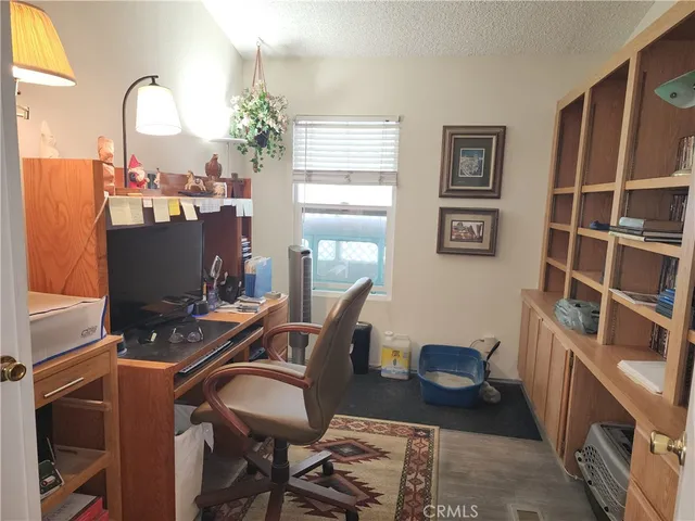 a view of a workspace with bookshelf