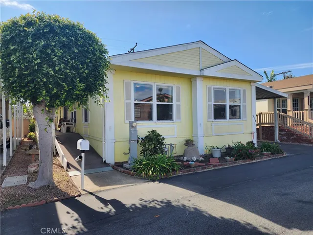 a front view of house with yard seating and green space