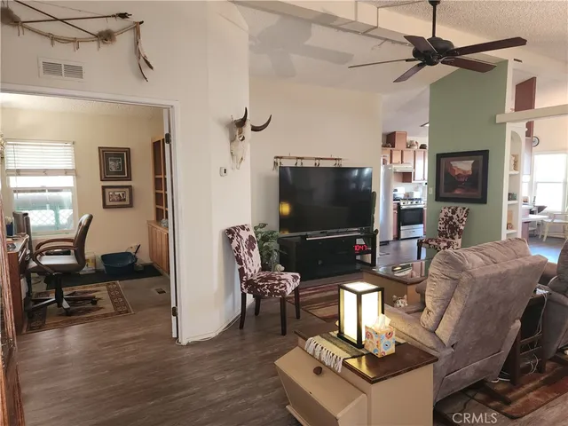 a living room with furniture a rug and a flat screen tv