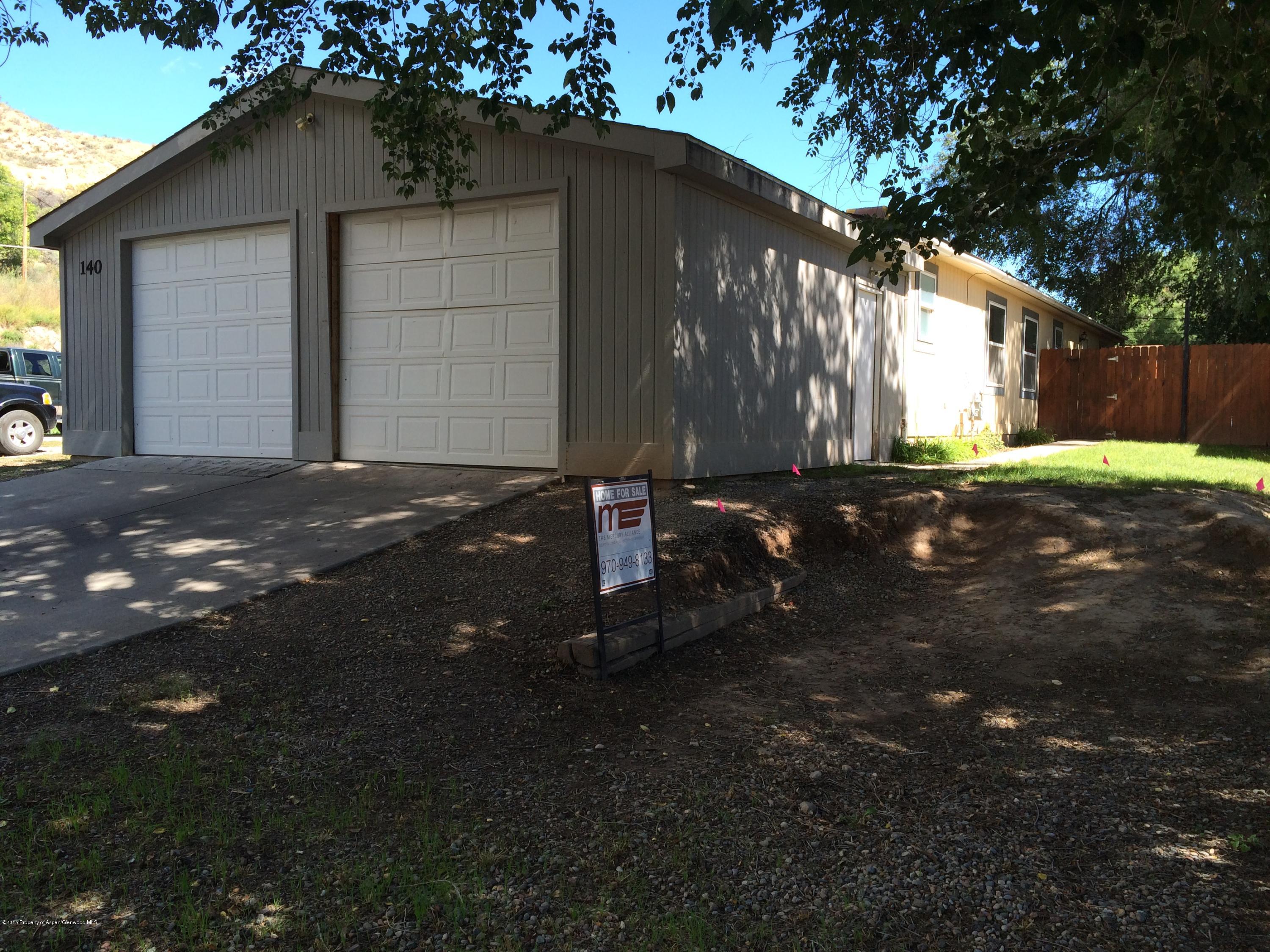 140 Ray Street Rifle, CO 81650 - Photo 1 of 11 a backyard of a house with table and chairs