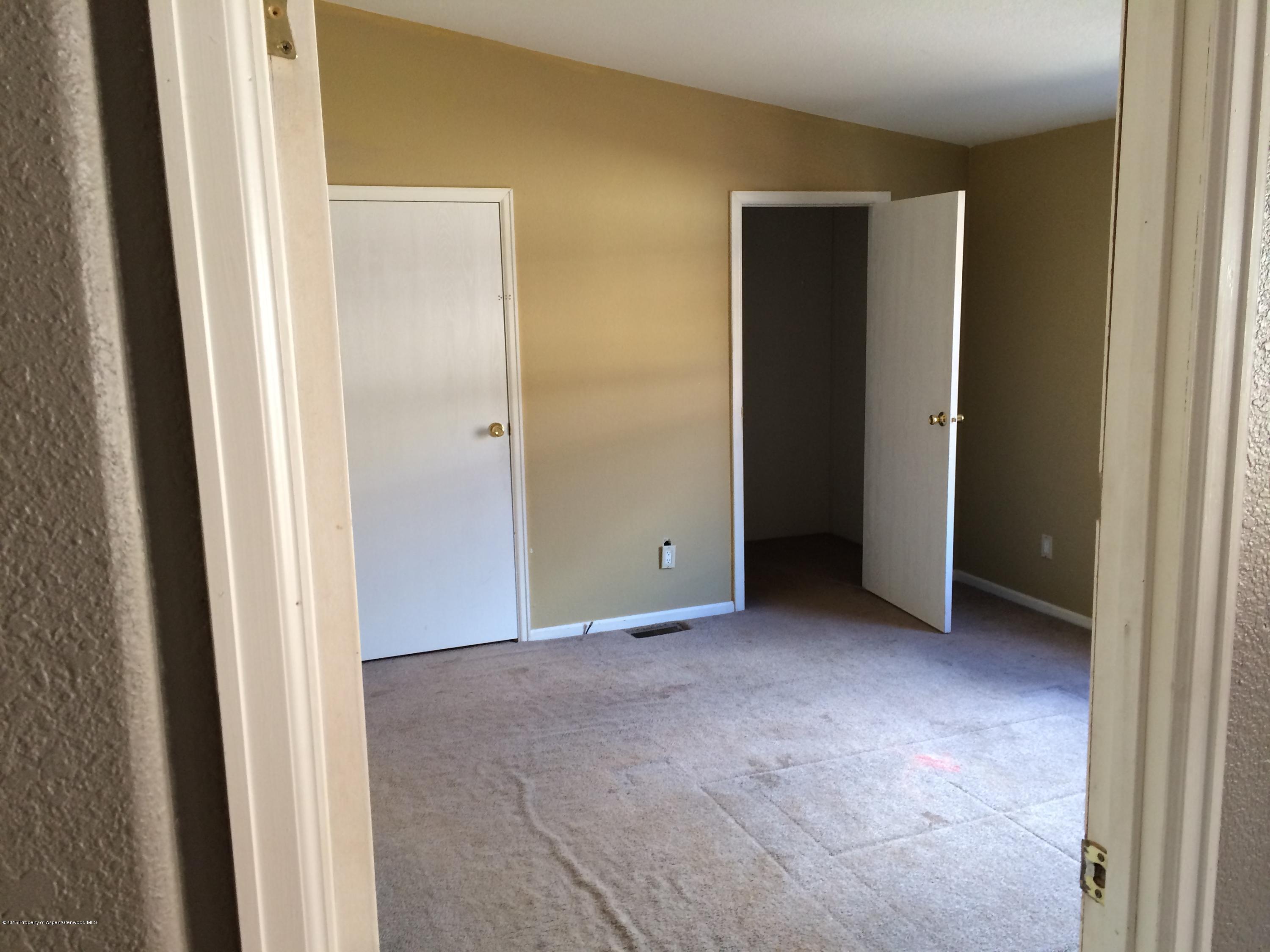 140 Ray Street Rifle, CO 81650 - Photo 5 of 11 a view of an empty room with closet and wooden floor