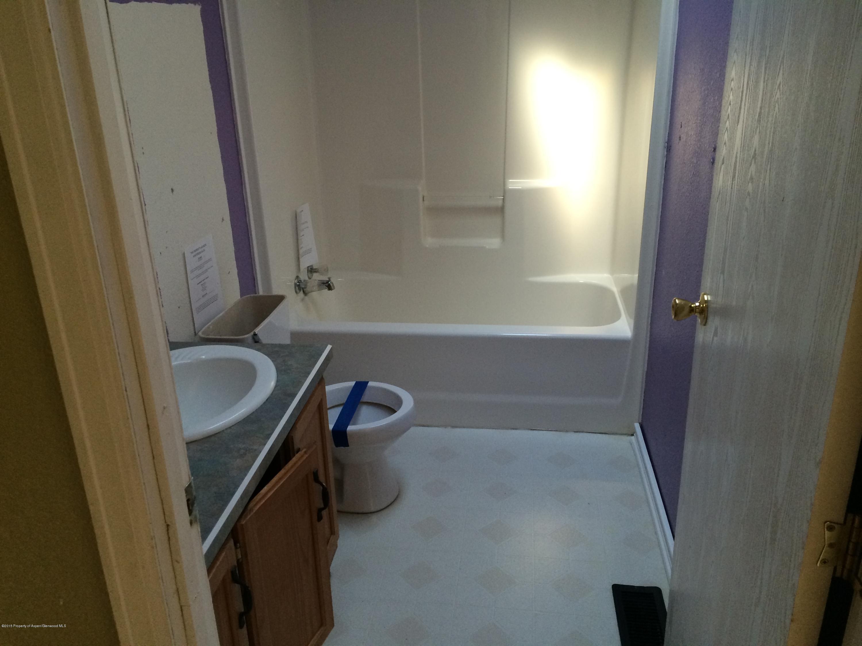 140 Ray Street Rifle, CO 81650 - Photo 9 of 11 a bathroom with a sink and a tub