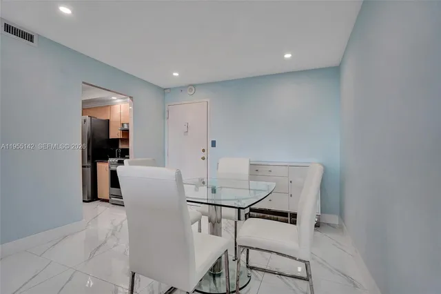 a kitchen with stainless steel appliances granite countertop a refrigerator a stove and a sink with dishwasher