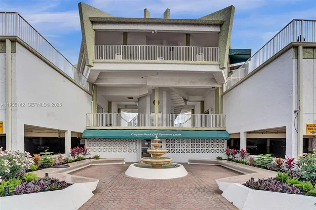 a view of a swimming pool with outdoor seating