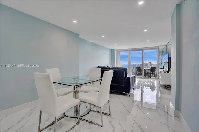 a living room with furniture a couch and a large window