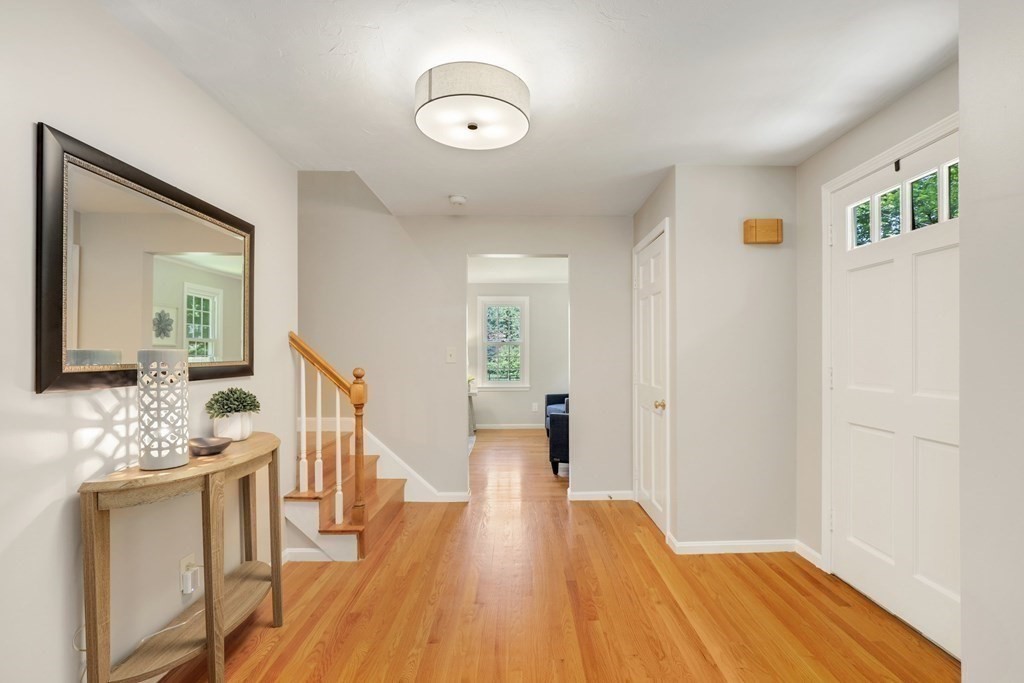 72 Nixon Road Framingham, MA 01701 - Photo 4 of 42 a view of a hallway with wooden floor and staircase
