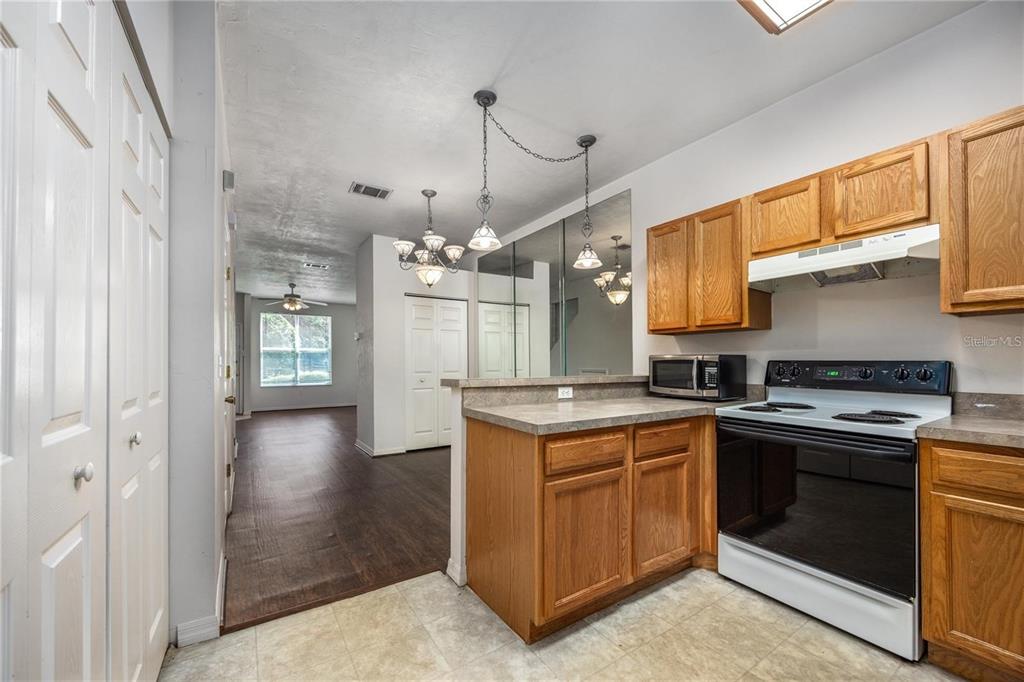3510 Southwest 30th Way, Unit 158 Gainesville, FL 32608 - Photo 14 of 27 a kitchen with stainless steel appliances granite countertop a stove and a refrigerator