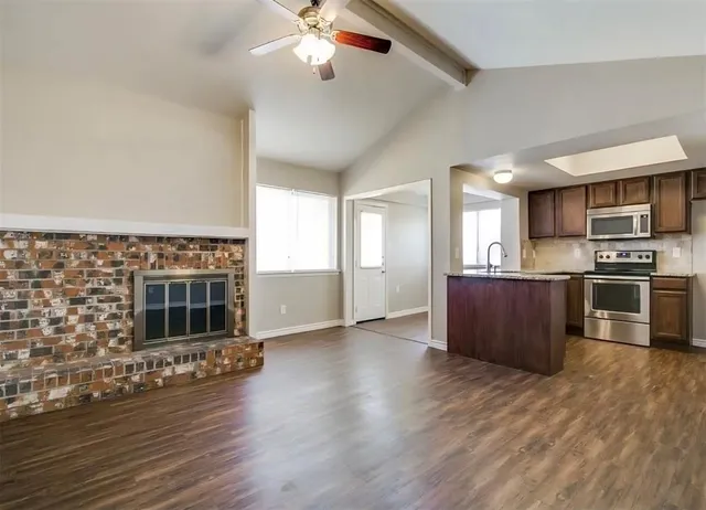a view of a kitchen with a stove cabinets and wooden floor