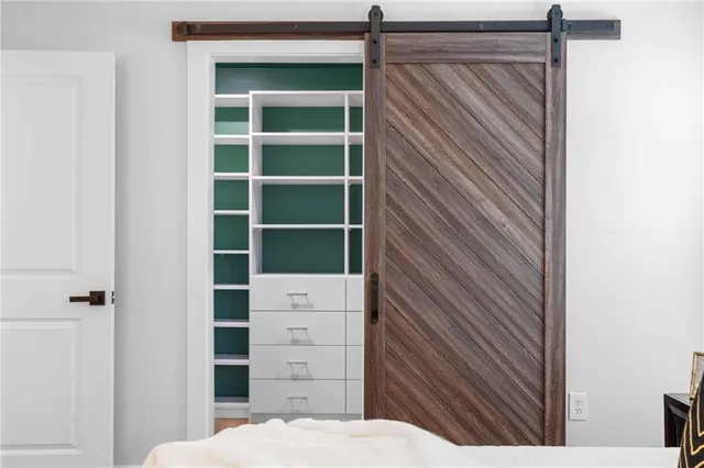 a bathroom with a granite countertop tub sink a toilet a mirror and shower