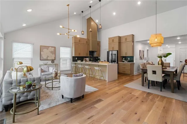 a living room with lots of furniture and kitchen view