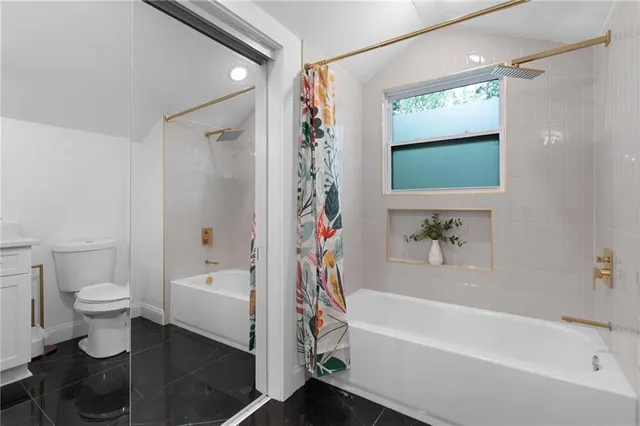 a view of a backyard with a small cabin and wooden fence