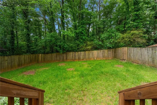 a view of a cafe with a table and chairs under an umbrella