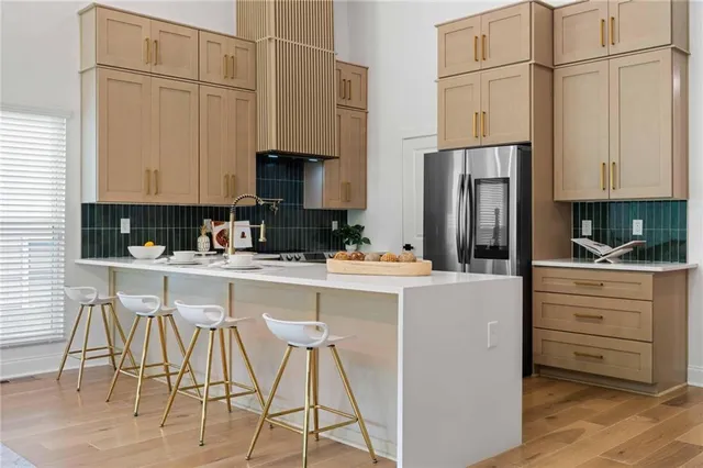 a kitchen with stainless steel appliances a refrigerator sink and cabinets