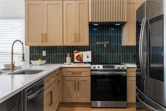 a kitchen with a sink stove and cabinets